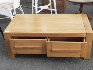 light oak coffee table with drawers.